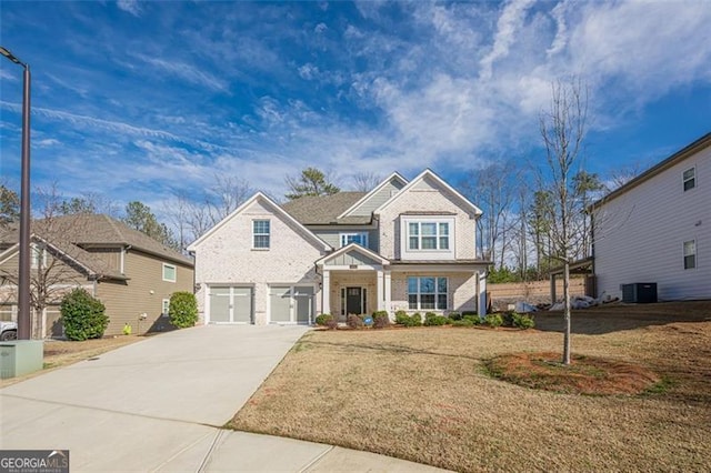 craftsman house with a garage, a front yard, and central air condition unit