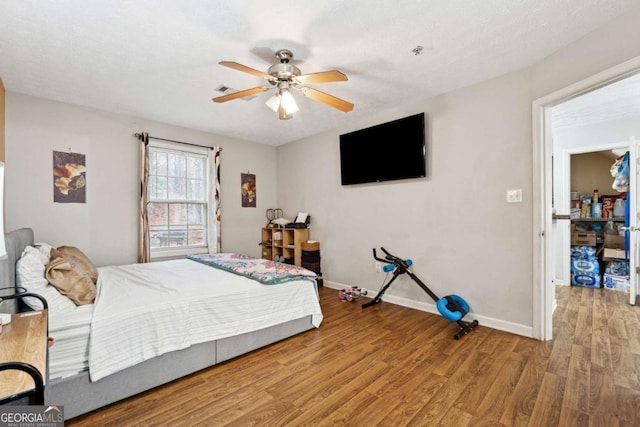 bedroom with wood-type flooring and ceiling fan