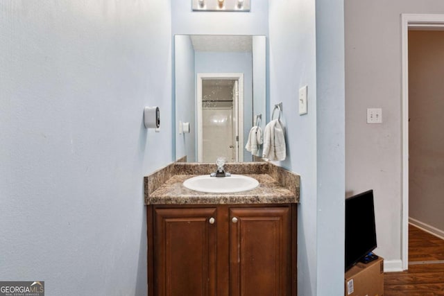 bathroom with vanity and hardwood / wood-style floors