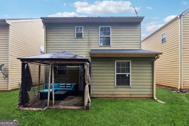 back of house with a gazebo and a lawn