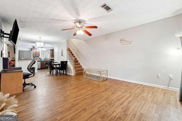 office featuring ceiling fan, a textured ceiling, and light hardwood / wood-style flooring