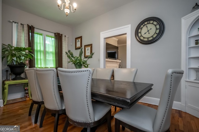 dining area featuring hardwood / wood-style floors and a notable chandelier