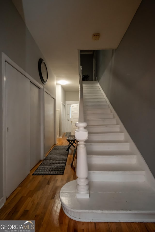 stairs featuring hardwood / wood-style flooring