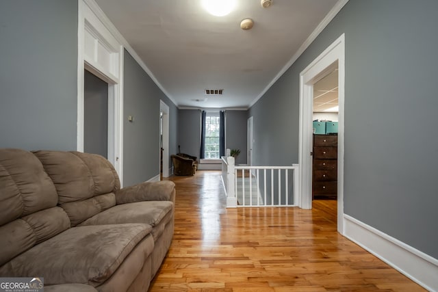 living room featuring crown molding and light hardwood / wood-style flooring