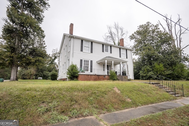 colonial-style house with a front lawn and a porch