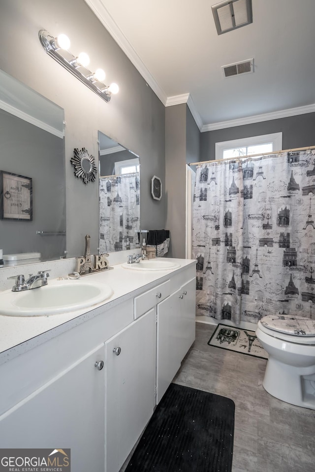 bathroom featuring toilet, crown molding, wood-type flooring, vanity, and a shower with shower curtain