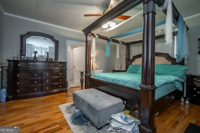 bedroom featuring hardwood / wood-style floors, crown molding, and ceiling fan