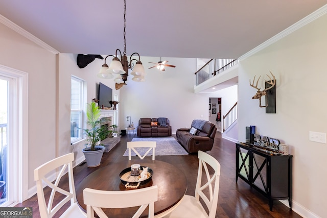 dining room with an inviting chandelier, ornamental molding, and dark wood-type flooring