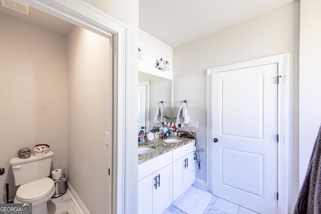 bathroom featuring vanity and toilet