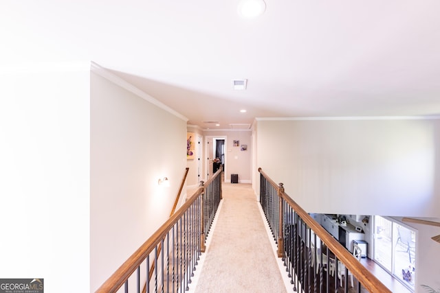 corridor featuring crown molding and light colored carpet