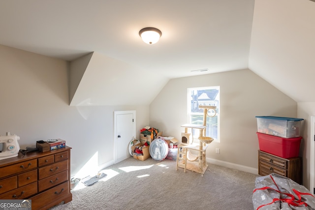 interior space featuring vaulted ceiling and light carpet