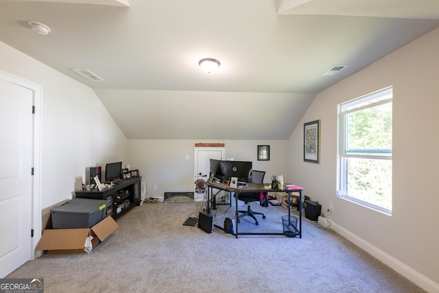 carpeted office space featuring lofted ceiling