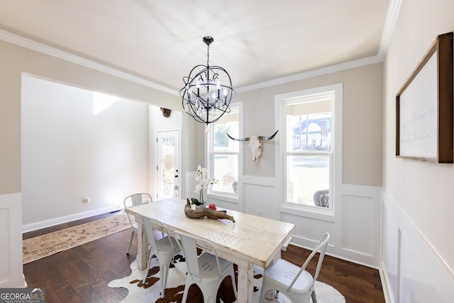 dining space with crown molding, dark hardwood / wood-style floors, and an inviting chandelier