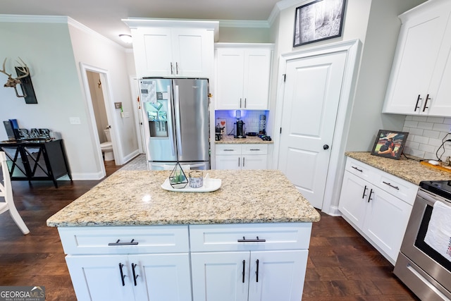 kitchen featuring white cabinetry, ornamental molding, and appliances with stainless steel finishes