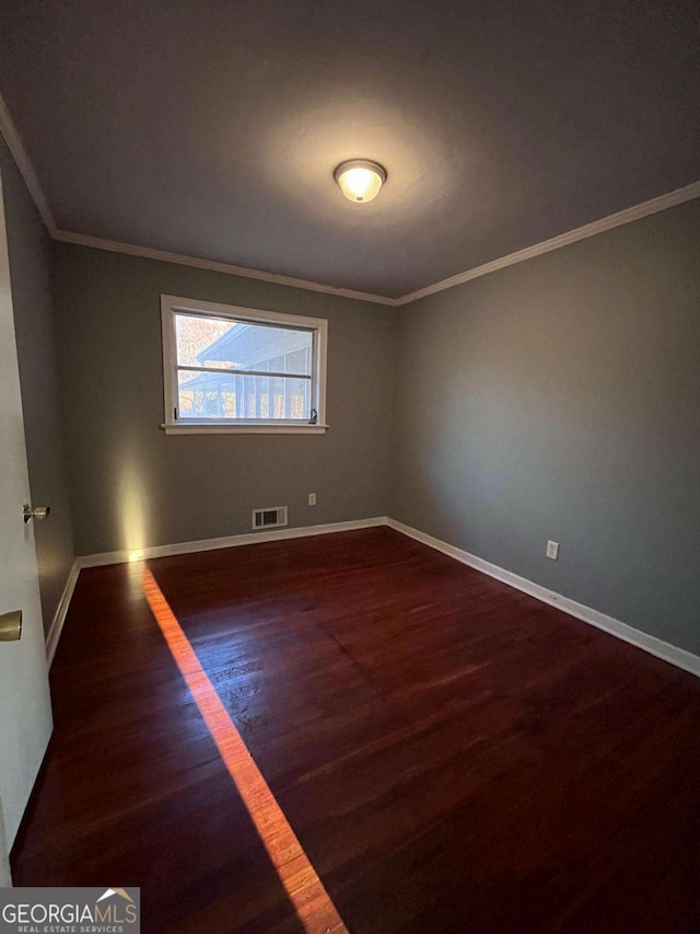 unfurnished room featuring crown molding and dark hardwood / wood-style floors