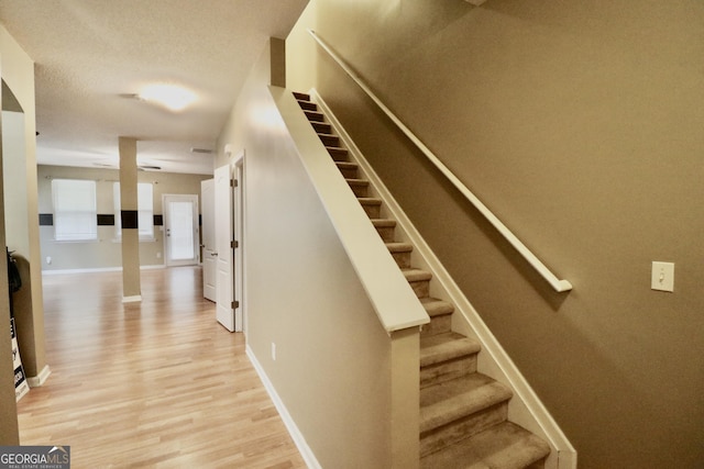 stairway with hardwood / wood-style floors