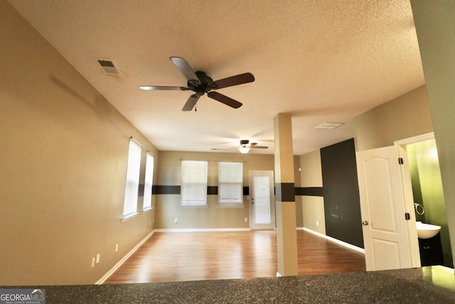 spare room with hardwood / wood-style floors and a textured ceiling