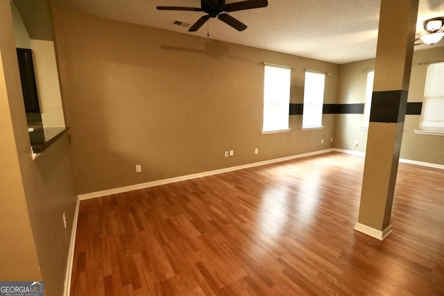 empty room featuring hardwood / wood-style floors and ceiling fan