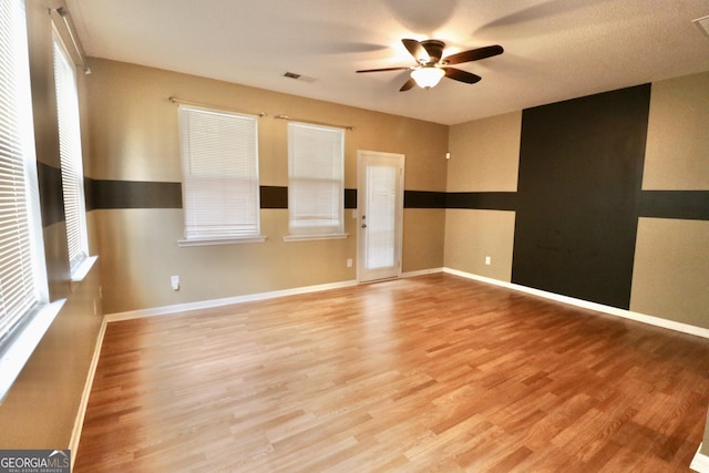 unfurnished room featuring ceiling fan and light hardwood / wood-style floors