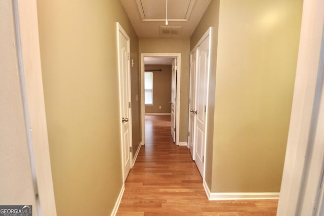 hallway with light wood-type flooring