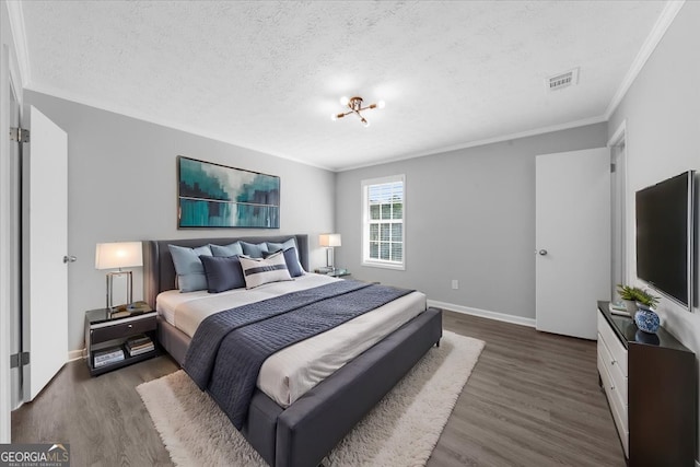 bedroom featuring crown molding, dark hardwood / wood-style floors, and a textured ceiling