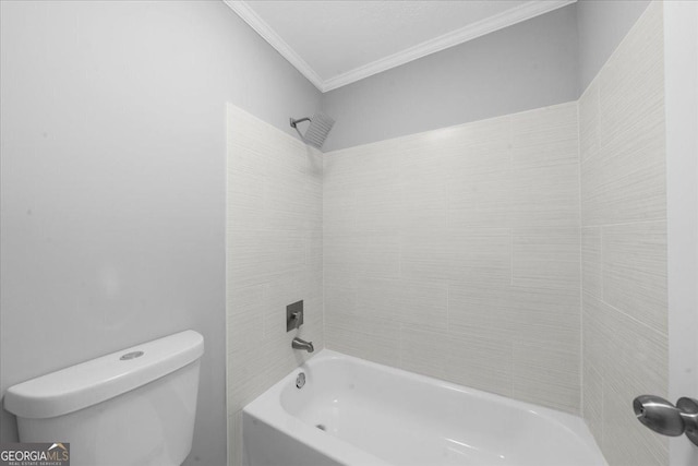 bathroom featuring tiled shower / bath, crown molding, and toilet