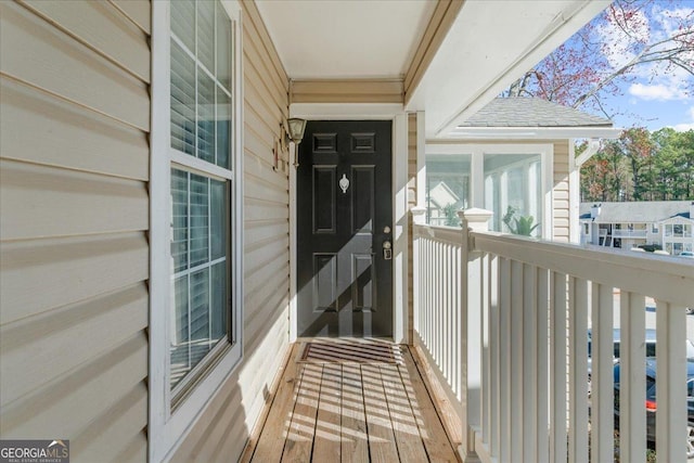 view of exterior entry with a balcony