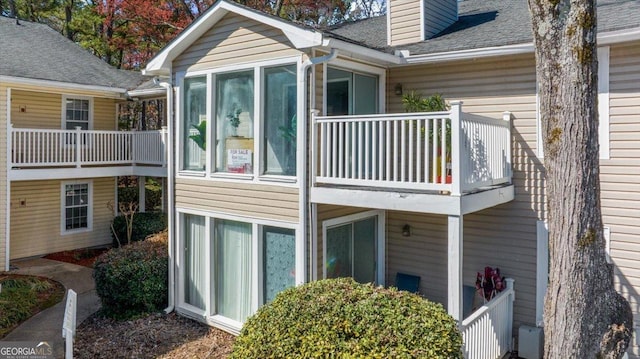 rear view of property featuring a balcony