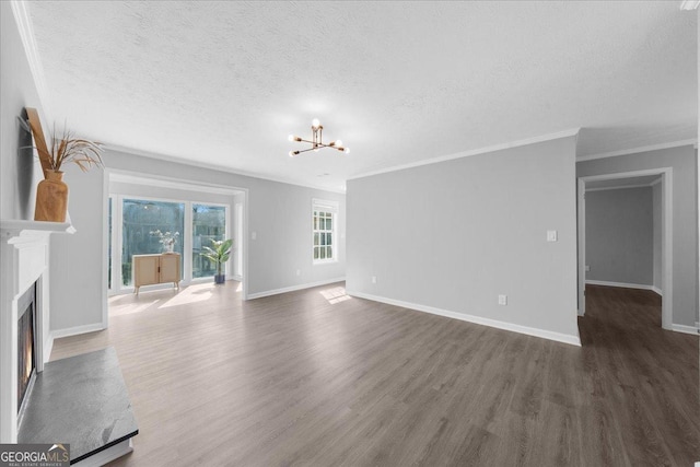 unfurnished living room featuring crown molding, dark wood-type flooring, a textured ceiling, and an inviting chandelier