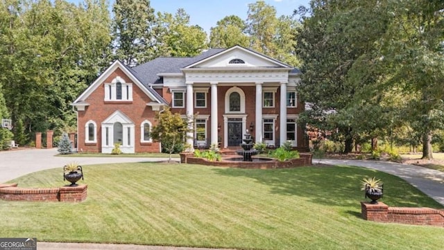 neoclassical / greek revival house with a front lawn