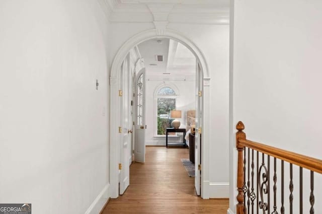 corridor featuring crown molding and light hardwood / wood-style floors