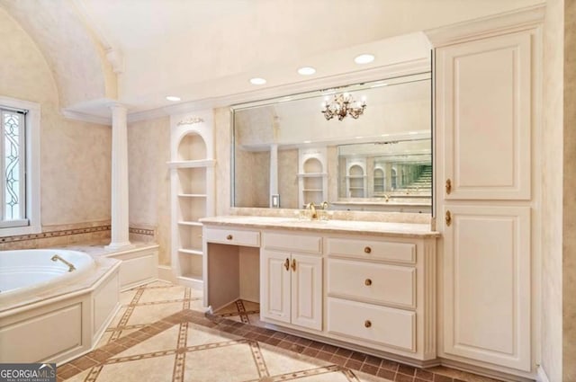 bathroom featuring vanity, ornamental molding, built in shelves, a bathing tub, and ornate columns