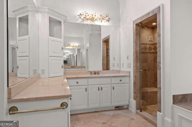 bathroom featuring vanity, tile patterned flooring, and a shower with door