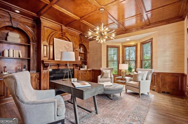 living area featuring built in shelves, coffered ceiling, wood ceiling, an inviting chandelier, and light hardwood / wood-style floors