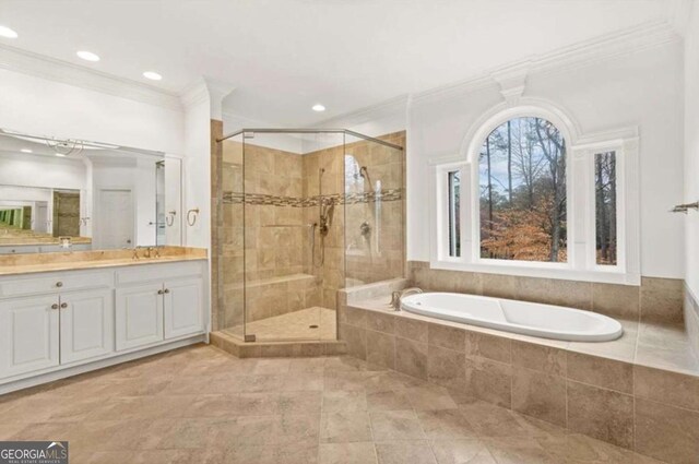 bathroom featuring crown molding, vanity, and plus walk in shower