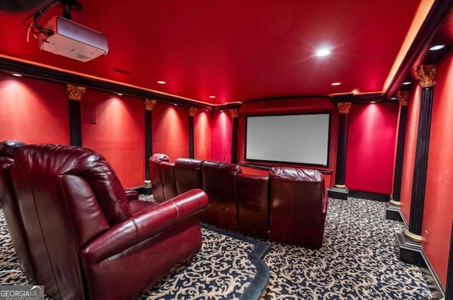 home theater room featuring decorative columns and carpet