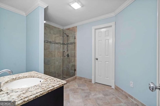 bathroom featuring a shower with door, crown molding, and vanity