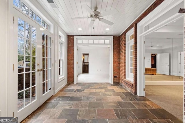 unfurnished sunroom featuring wooden ceiling, french doors, and ceiling fan