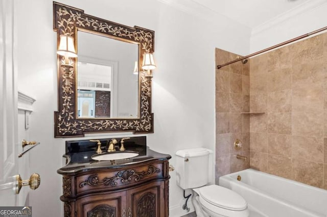 full bathroom with crown molding, tiled shower / bath, vanity, and toilet