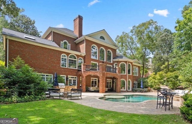 rear view of property featuring a lawn and a patio