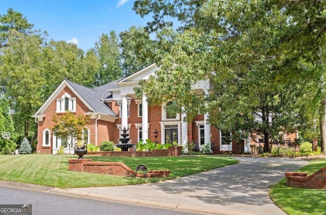 neoclassical / greek revival house featuring a front lawn