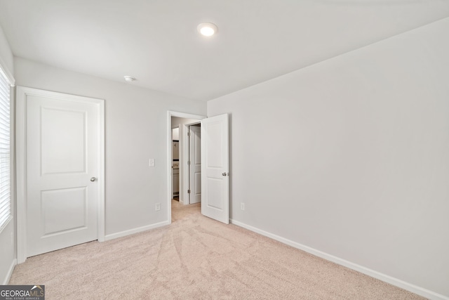 unfurnished bedroom with light carpet