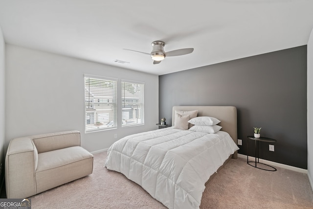 bedroom with light carpet and ceiling fan