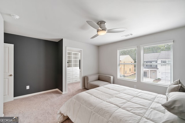 bedroom with ceiling fan and light colored carpet