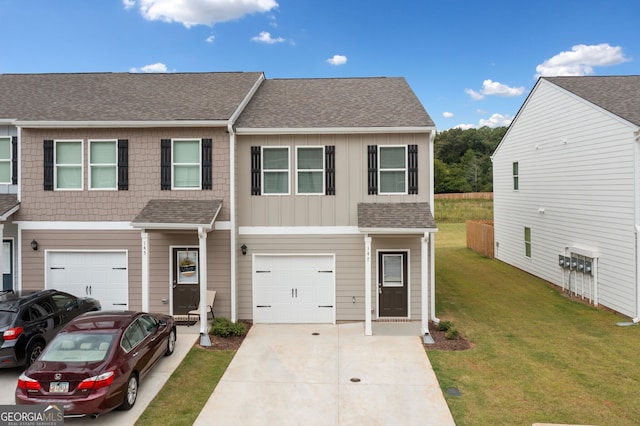 view of property with a front lawn and a garage