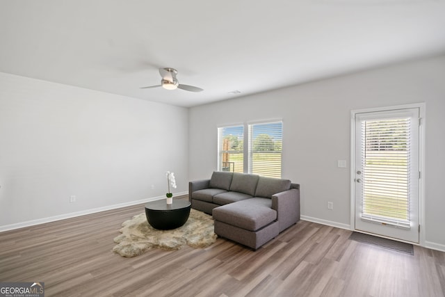 living room with ceiling fan, light hardwood / wood-style floors, and a healthy amount of sunlight