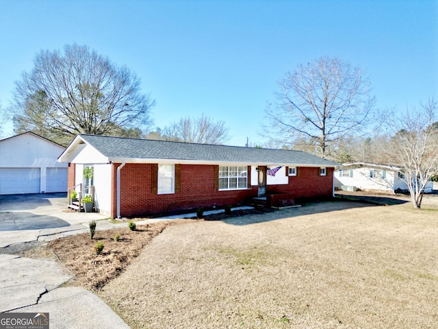 single story home featuring a garage and an outbuilding