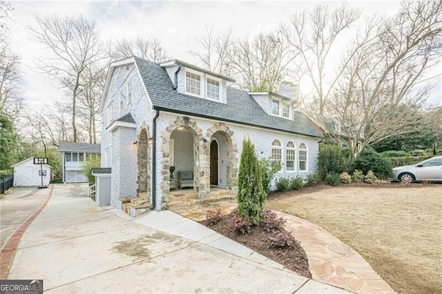 view of front of home featuring a shed