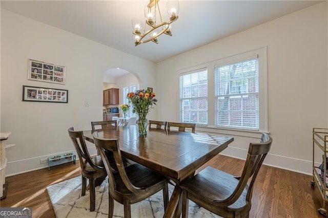 dining area with an inviting chandelier and hardwood / wood-style floors