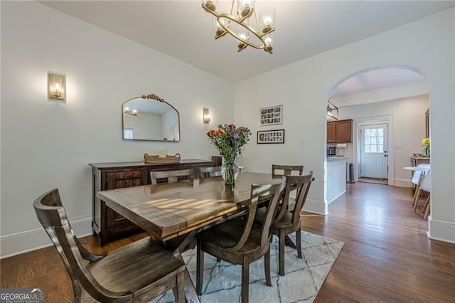 dining room featuring wood-type flooring and a chandelier